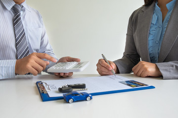 Car dealership provides advice about insurance details and car rental information and delivers the...