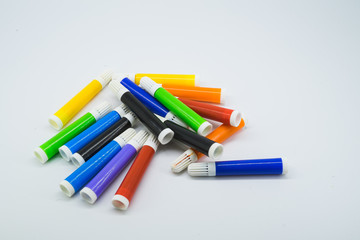 Colourful school supplies, markers stationery on white background - space for caption