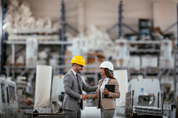 Businessman and businesswoman handshaking