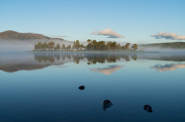 A small island in a lake on a tranquil, foggy morning. Ottsjon, Sweden.