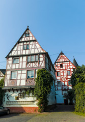 Fototapeta na wymiar Street in old German town with traditional medieval timber framing houses