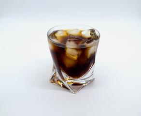 glass of whiskey and ice on white background
