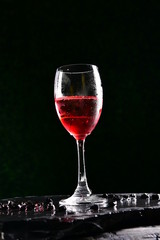 Alcoholic cocktails consisting of red fruit juices and soda water. Poured into a glass of wine by a professional bartender.