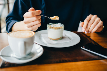 Woman in a cafe eating a dessert