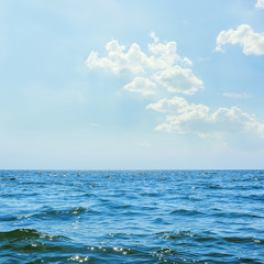 Obraz premium blue sea water and clouds in sky