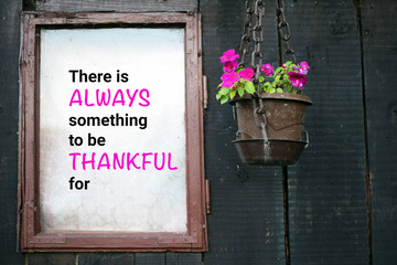 Old window and the flower pot. Note about gratefulness is in the window space.