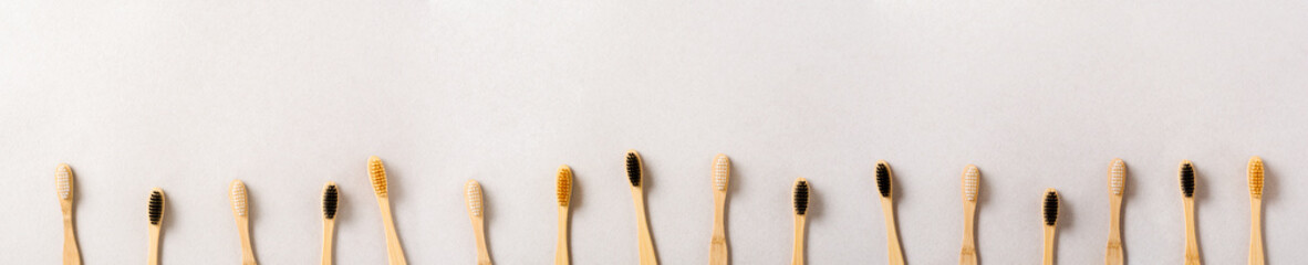 Eco materials concept with bamboo tooth brush on gray paper background. Zero waste, plastic free...