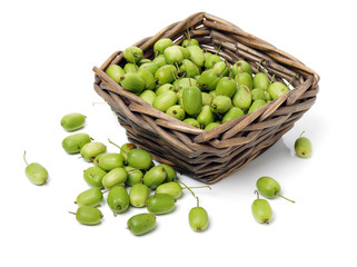 mini kiwi baby fruit (actinidia arguta) on white background