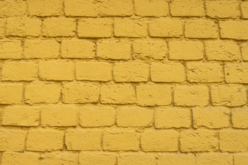 Background yellow brick wall. Plastered wall.