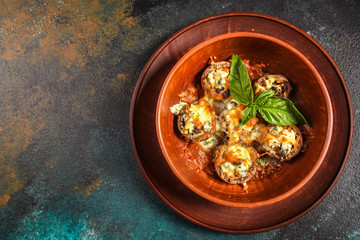 mushroom stuffed cheese (delicious baked vegetable dish, no meat) menu concept. food background. copy space. Top view