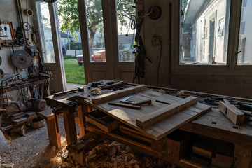 Photo of nice home wood workshop, a lot of tools on the table and hang on the wall