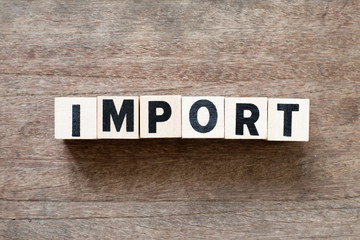 Fototapeta premium Letter block in word import on wood background