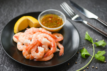 fresh shrimps served on plate with seafood sauce - boiled peeled shrimp prawns cooked in the restaurant