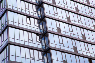 The facade of a modern office building made of glass and concrete.Horizontally.