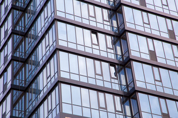 The facade of a modern office building made of glass and concrete.Horizontally.