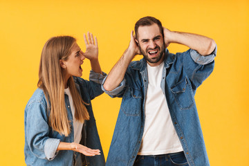 Image of aggressive woman in denim clothes screaming at displeased man