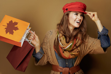 middle age woman with autumn shopping bags looking aside