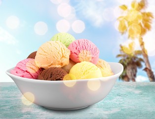 Ice cream scoops in bowl on white background