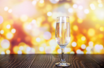 prosecco glass holiday drinks like themed party and holiday celebration with Champagne glasses for winter holidays decorated christmas lights bokeh gold background