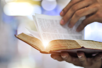 Man holding Open book in hands. Male hands hold a hardcover book. Education, literature, knowledge, reading concept. Copy space.