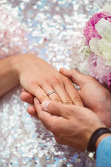 Obraz na płótnie Canvas Wedding couple hands with rings near wedding bouquet. Marriage concept.