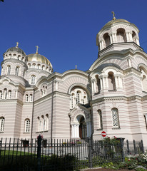Fototapeta premium View on the Nativity of Christ Cathedral in Riga, Latvia with its sunny golden domes shining in the sun. It was built in a Neo-Byzantine style and is the largest cathedral