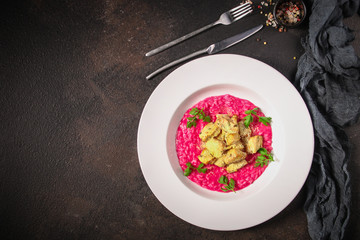 risotto chicken meat (red rice with beetroot flavor) menu concept. food background. copy space. Top view