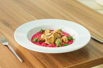 risotto chicken meat (red rice with beetroot flavor) menu concept. food background. copy space. Top view