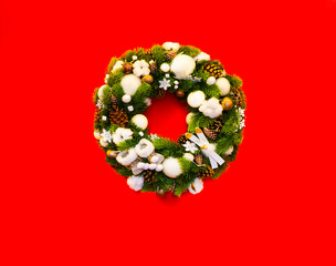 Obraz na płótnie Canvas New year card, christmas wreath on red, background, selective focus, copy space 