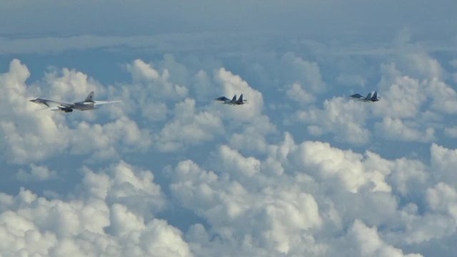 Two su-27 accompany Tu-160 in the sky