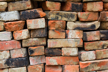 Old red stacked bricks, abstract background.