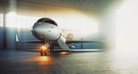 Fototapeta premium Business private jet airplane parked at maintenance hangar and ready for take off. Luxury tourism and business travel transportation concept. 3d rendering