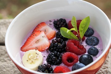 Acai bowl with fresh organic strawberry, raspberry,mulberry,blueberry,banana,sesame seeds and chia seeds