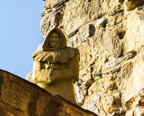 sandstone statue of a monk looking down
