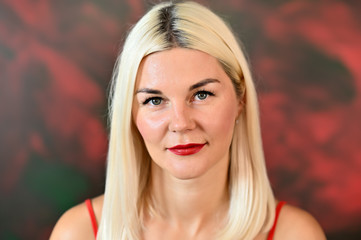 Naklejka premium Close-up portrait of a pretty caucasian woman with blond hair on a colored background. Great makeup, good facial skin.