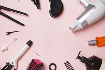 Hair styling and care items and products on pink background