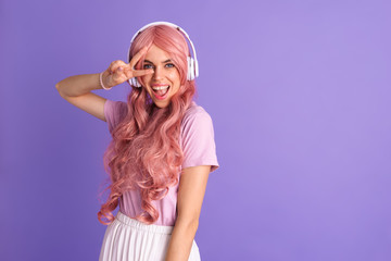 Optimistic young girl listening music with headphones.