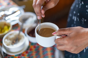Making a coffee. Stirring coffee with a spoonMaking a coffee. Stirring coffee with a spoon