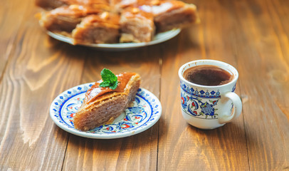Turkish coffee and baklava on the table. Selective focus.