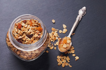 Homemede granola with nuts and seeds in a glass jar