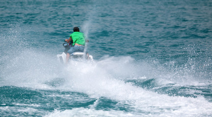A man rides a water bike in the water