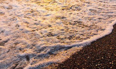 Waves on the seashore at sunset