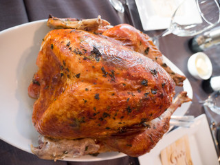 A close up of large home made mouthwatering oven roasted whole turkey with spice rub with breast...