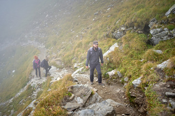 People with backpacks hiking into the mountains