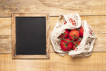 Chalkboard next to bag of tomatoes