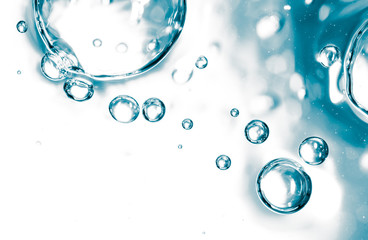 Bubbles of air on the smooth surface of blue water as an abstract background