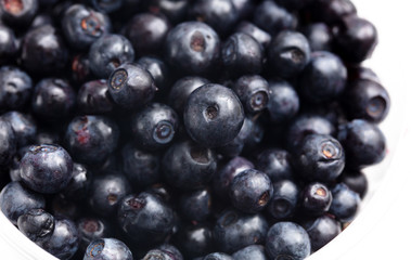 Blueberries in a glass on a white background