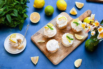 Lemon cupcakes with poppy seeds, white butter cream and  slice of lemon