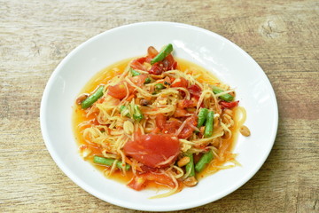 Som tum Thai spicy green papaya salad on dish 