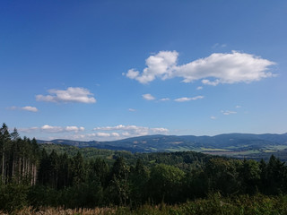 Summer landscape in mountains and the dark blue sky with clouds